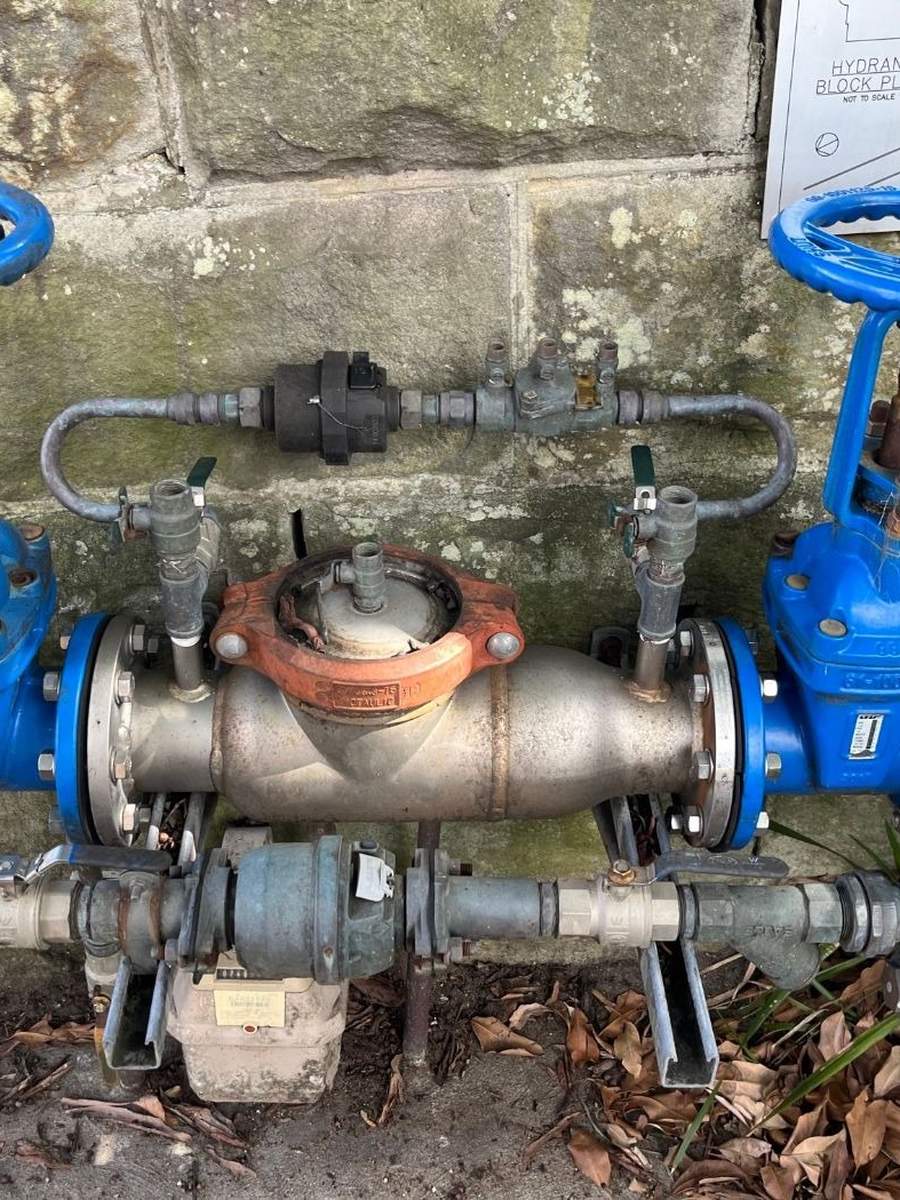 Water meter and backflow valve assembly on a commercial site