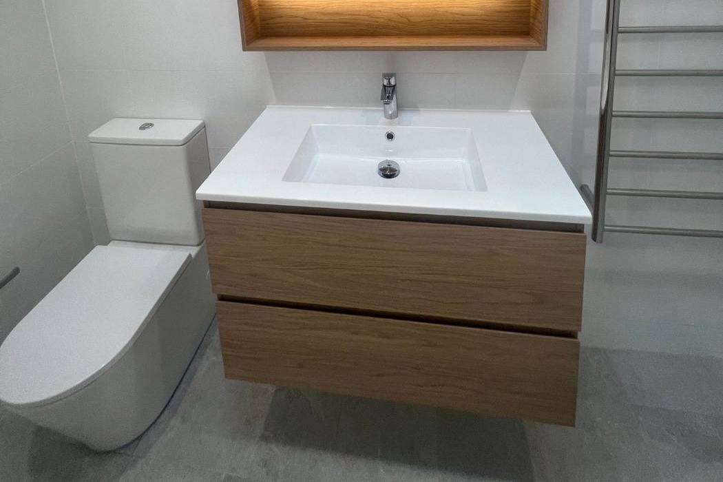 New timber vanity, toilet and heated towel rail in a finished bathroom