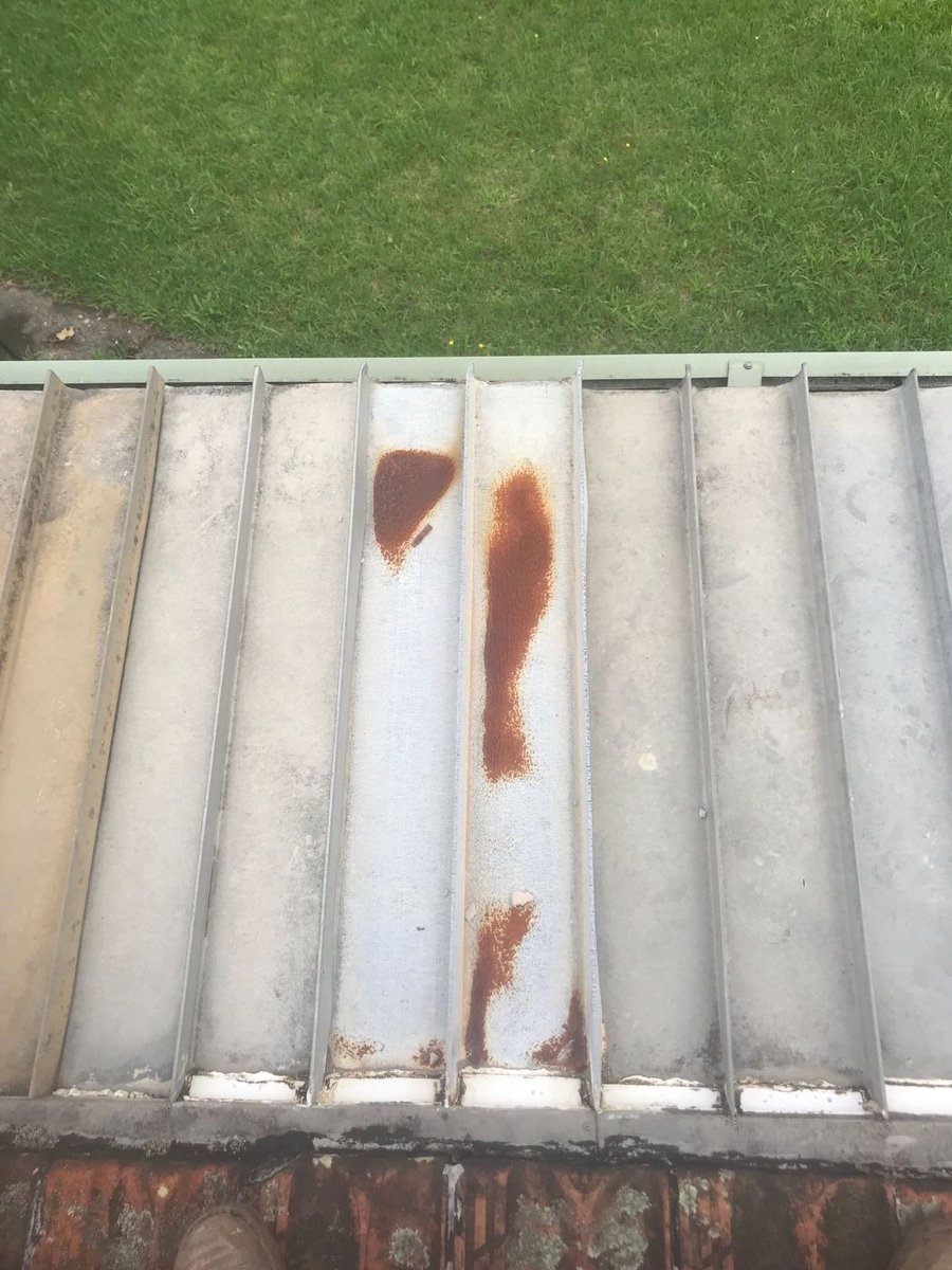 Old metal roof sheets with rust running down them