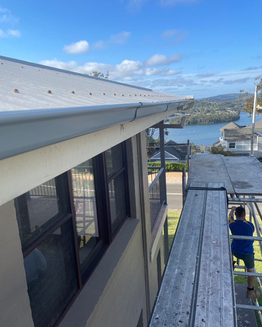 New gutters going on two storeys up, with a view to the water